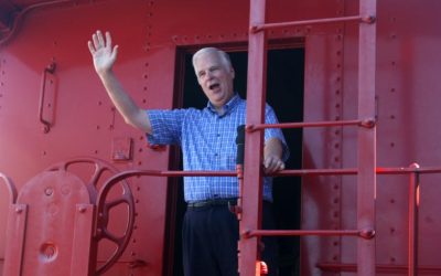 Larry James tries “electioneering” from the little red caboose at the Museum of American Trains.