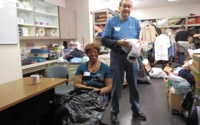 Jo Anne Blair and Tarek Radjef joined other TIAA members sort clothes at Crossroads Community Services in February 2016.